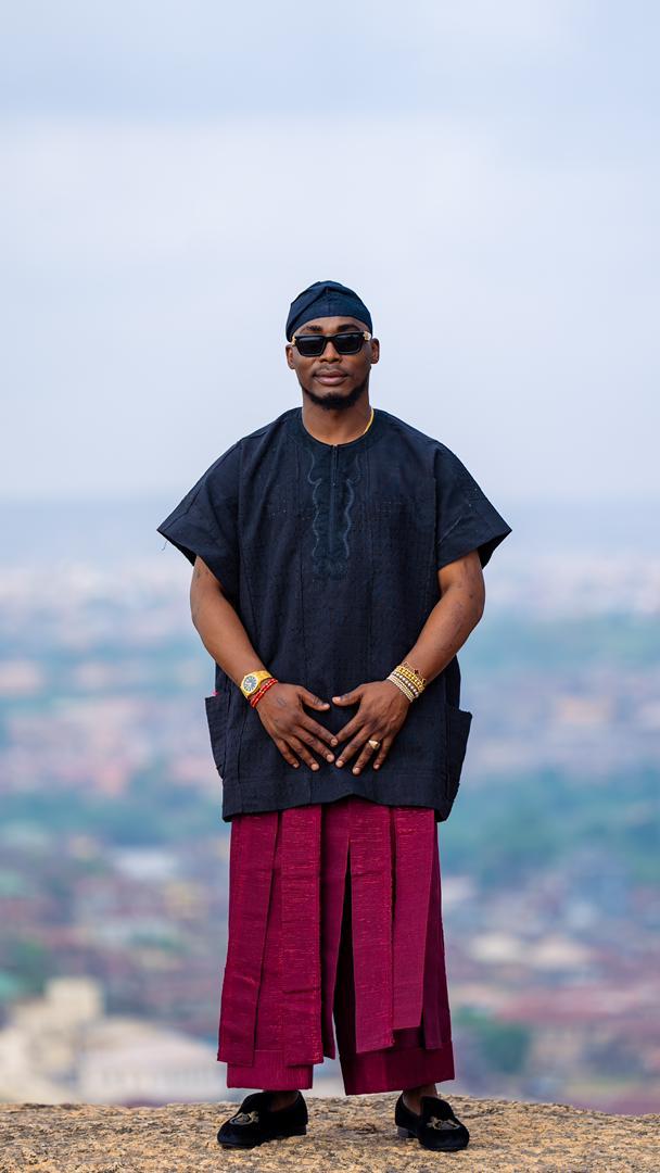 Omoba Kasali Adeboye standing on a hilltop overlooking the town